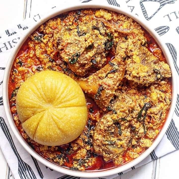 A bowl of GrubNmore egusi soup served with fufu swallow